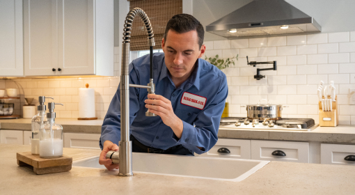 Plumber fixing bathroom faucet.